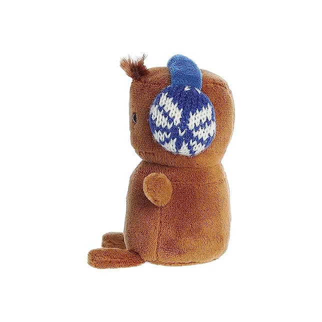 A brown plush gingerbread man with blue ear muffs and a red hat with white trim.