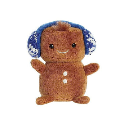 A brown plush gingerbread man with blue ear muffs and a red hat with white trim.