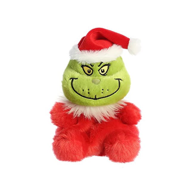 A green plush Grinch wearing a Santa hat. The Grinch has a big smile and a grumpy expression. 