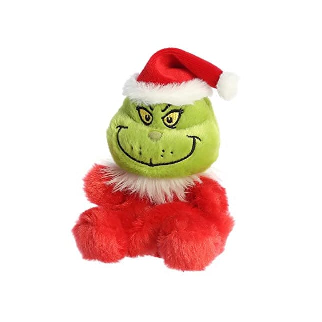 A green plush Grinch wearing a Santa hat. The Grinch has a big smile and a grumpy expression. 