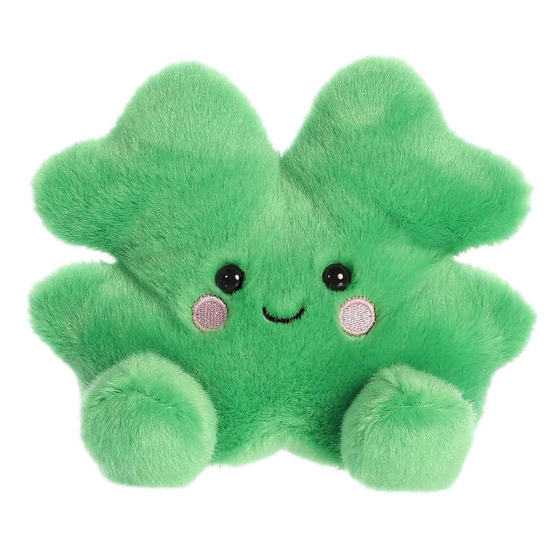 Stuffed four-leaf clover shaped toy with a smiley face. The clover is green and has four leaves.