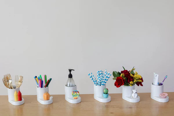 Container filled with pens, pencils, and straws on a table